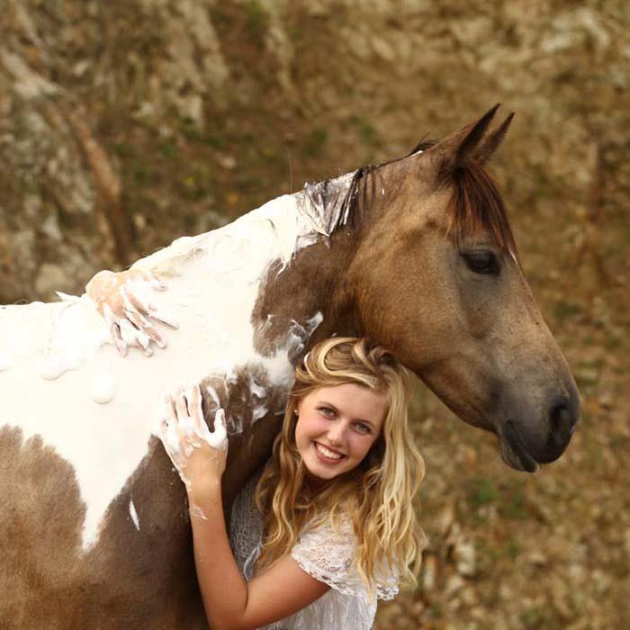 Smiling woman washing horse’s mane with Horse & Hound WashBar – deep-clean, all-natural shampoo bar for equine care